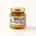 Petit pot hexagonal de caramel à l'érable au couvercle doré, posé sur un fond crème épuré avec ombre douce