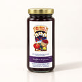 Pot de confiture de prunes de marque Les Serres Roch Hébert présenté debout sur un fond crème uniforme